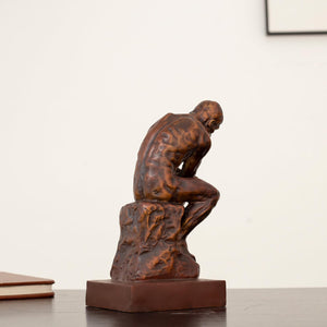 Rodin The Thinker classical bronze statue left side view displaying contemplative seated pose