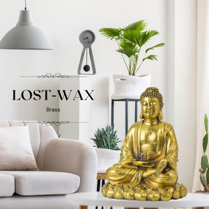 Brass Buddha statue in meditation lifestyle scene with woman practicing zen in bright room