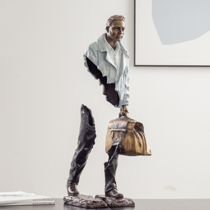 Close-up of the solid bronze base for the navy blue standing traveler statue.