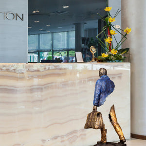 Back view of the arctic blue jacket finish on the large bronze traveler statue.