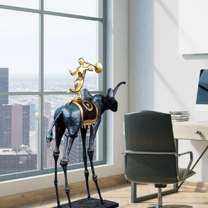 Surrealist bronze elephant statue beside armchair and window in contemporary living space