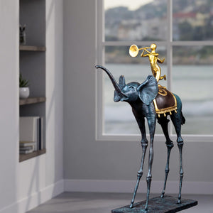 Surrealist bronze elephant statue displayed beside bookshelf in modern interior room