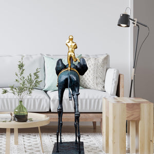Surrealist bronze elephant statue in bright living room setting with sofa and natural light