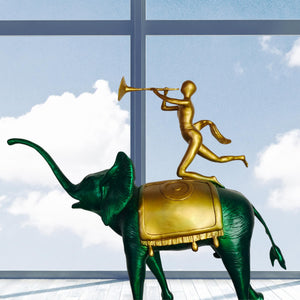 Surrealist bronze elephant statue displayed in living room beside large window as gallery art decor