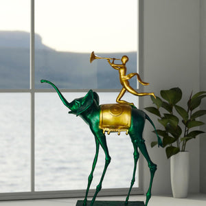 Surrealist bronze elephant statue beside window with mountain view as modern interior art accent