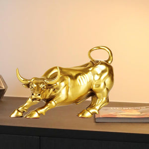 Front close-up of gold brass Wall Street bull horn detail.