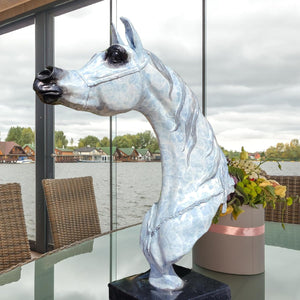 15-inch white patina bronze Arabian horse head sculpture on marble base displayed by lakeside window dining table