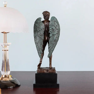 Winged David bronze statue styled as home decor beside a table lamp in warm ambient lighting