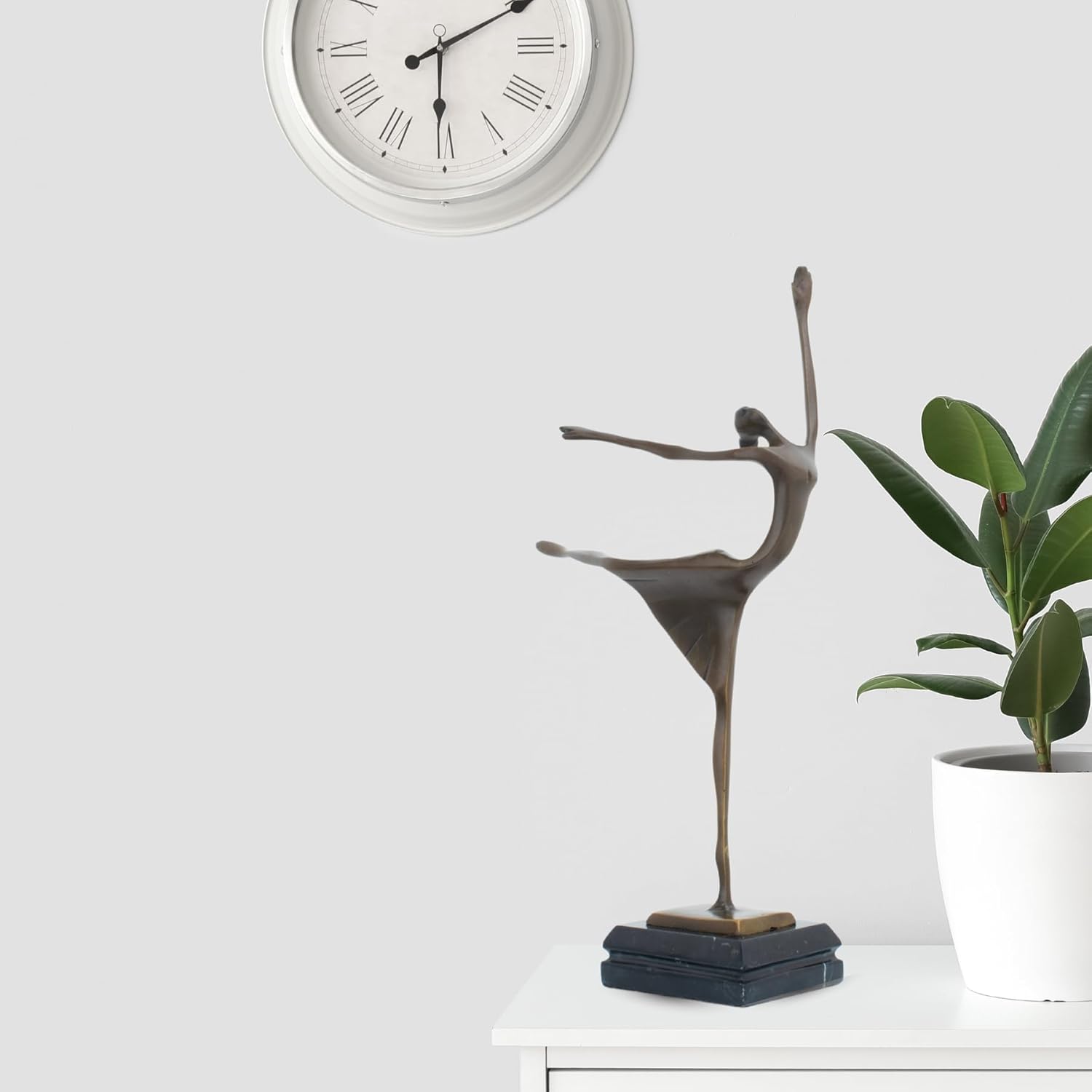 Abstract bronze ballerina dancer sculpture front full body view displayed with indoor plant decor