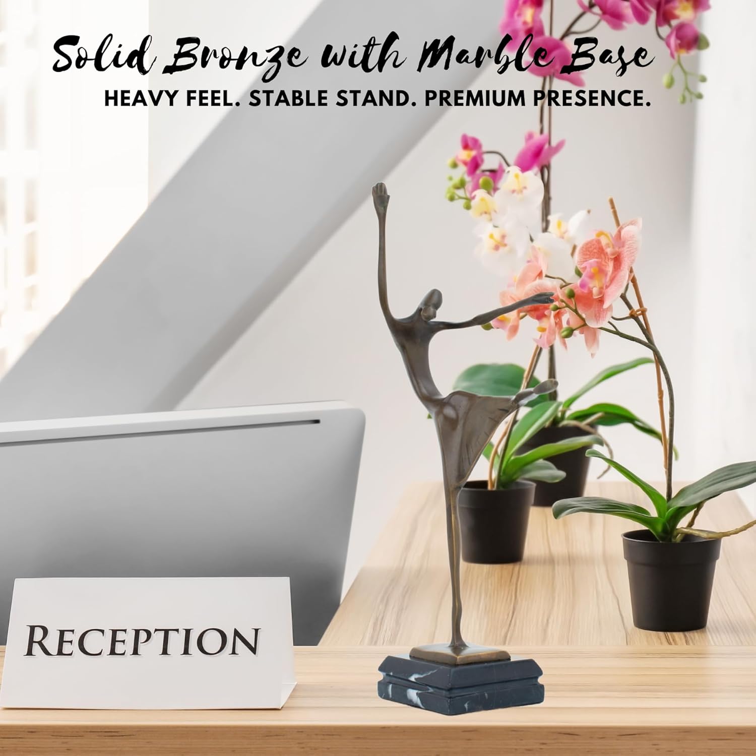 Abstract bronze ballerina sculpture on solid marble base displayed at reception desk setting