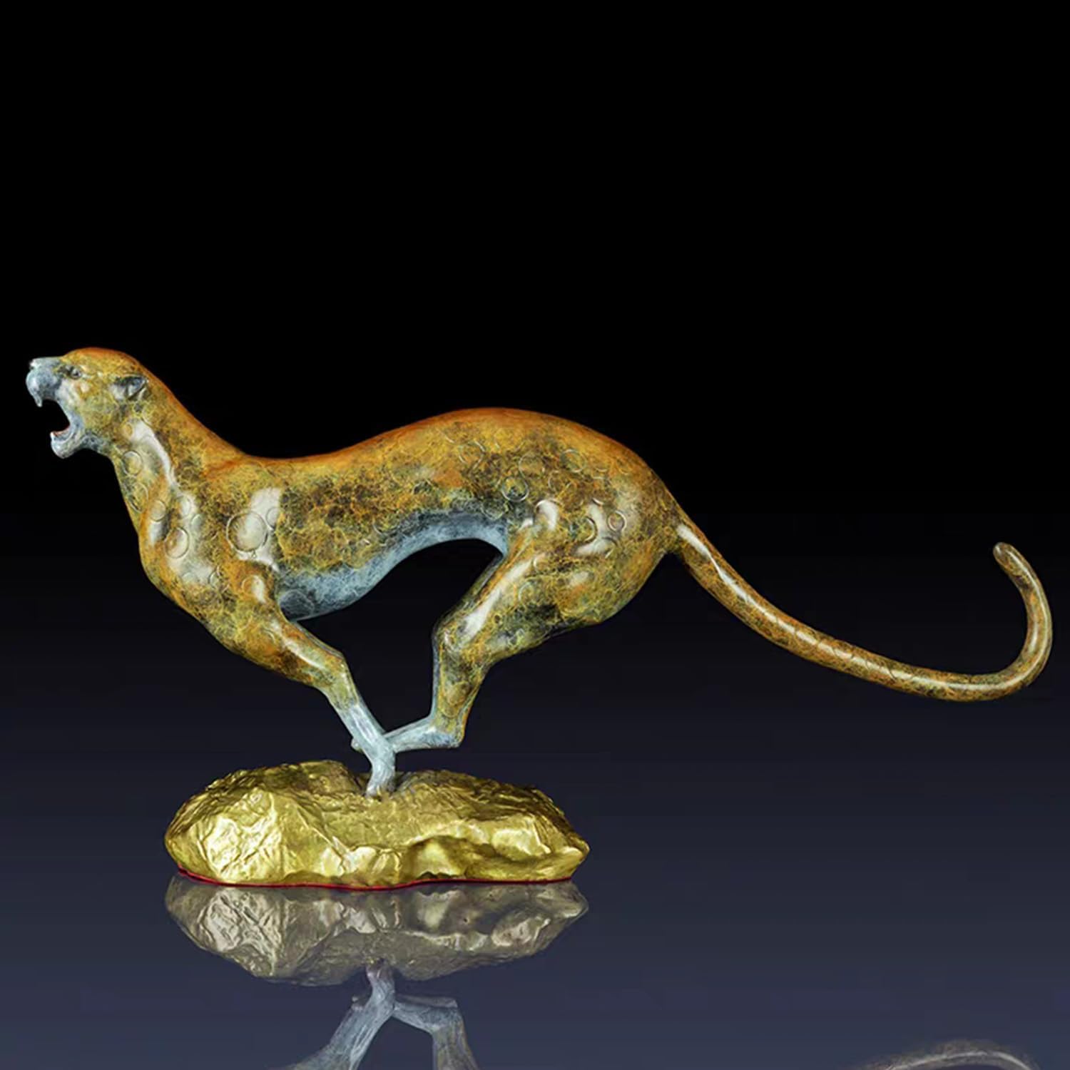 Front angle view of abstract bronze gold cheetah sculpture with open mouth on dark background