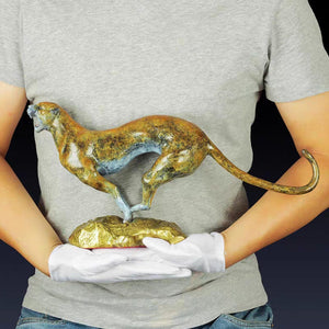 Person holding 16.5-inch abstract bronze gold cheetah sculpture showing human scale size comparison