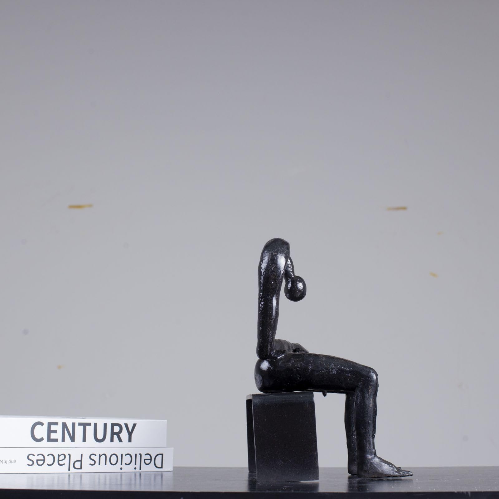 Albert György melancholy man bronze sculpture seated pose close up leg detail