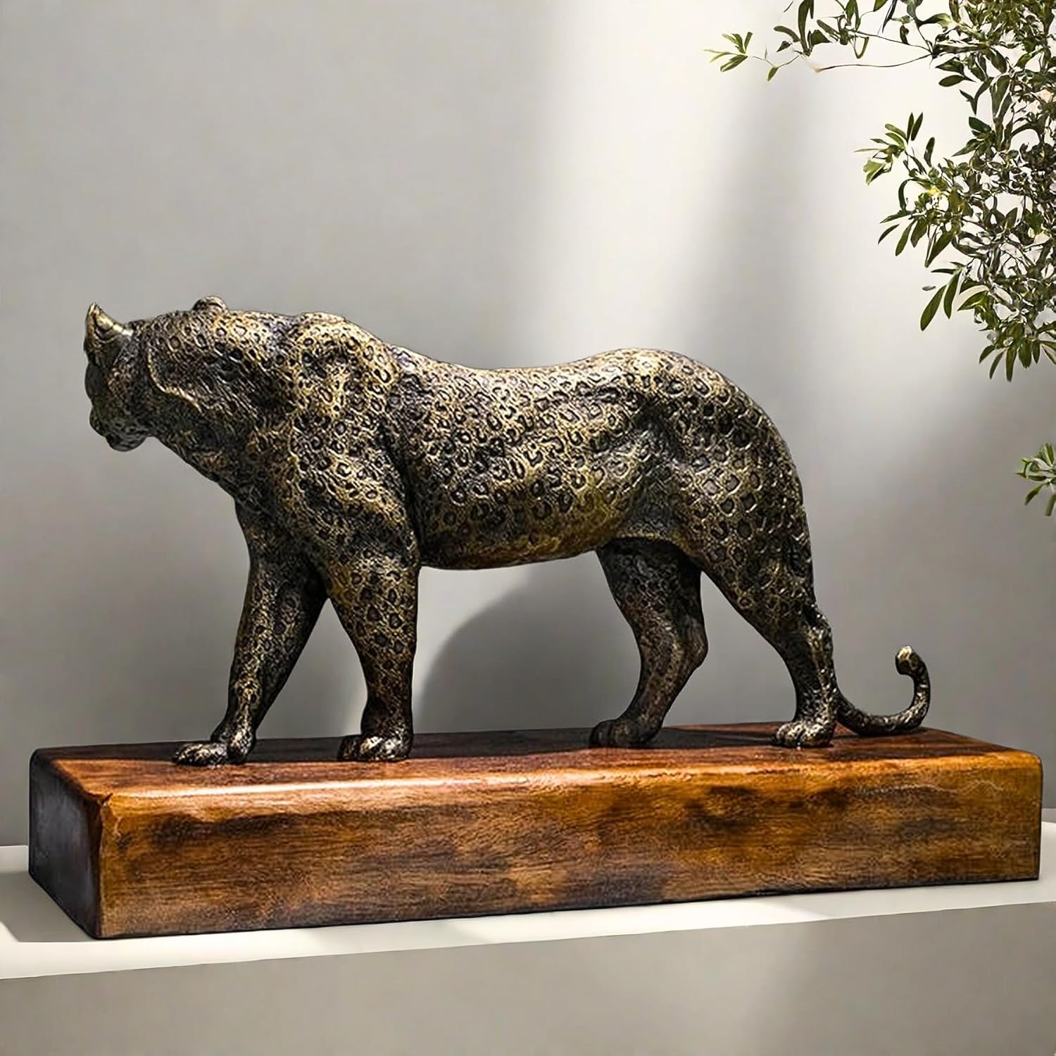 Back angle view of antique bronze money leopard statue with plant decor in indoor display