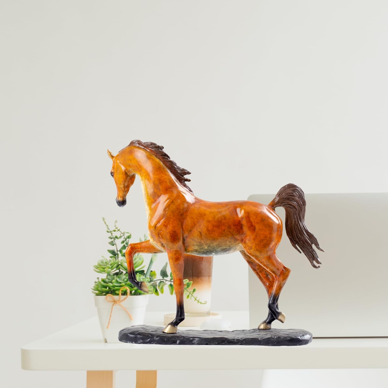 Arabian horse bronze sculpture on desk beside lamp as office or study room decor