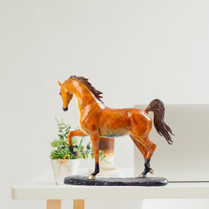 Arabian horse bronze sculpture on desk beside lamp as office or study room decor