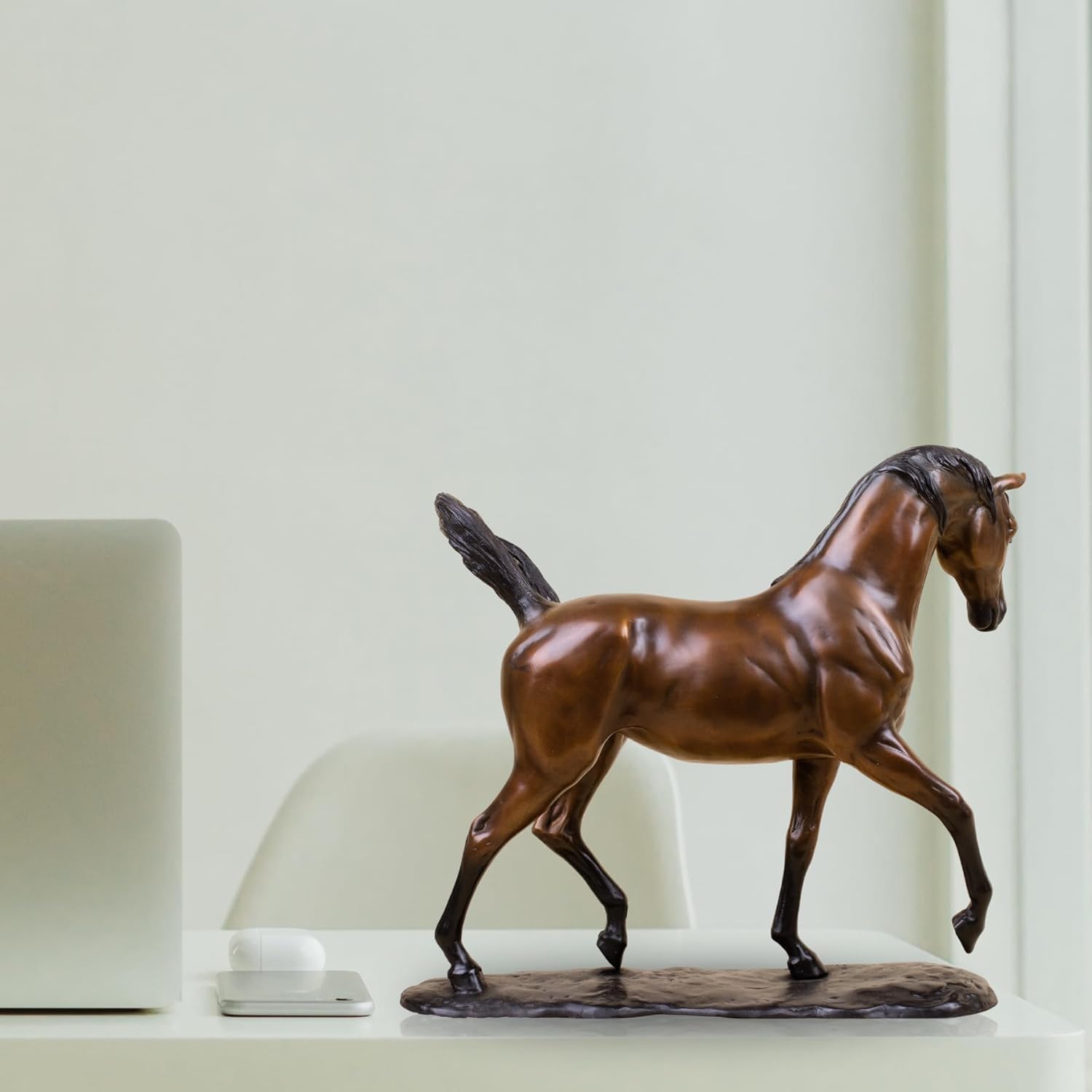 Antique chestnut Arabian stallion bronze sculpture side view on light background showing detailed mane