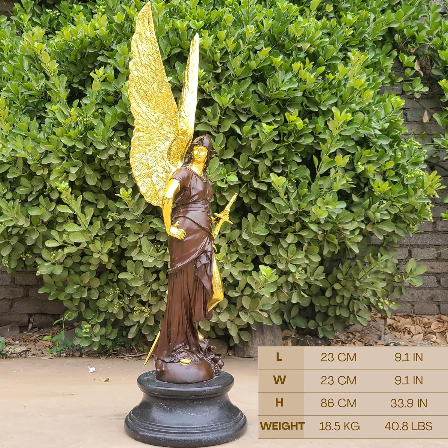 Left angle view of Athena angel wings bronze goddess sculpture displayed outdoors with greenery