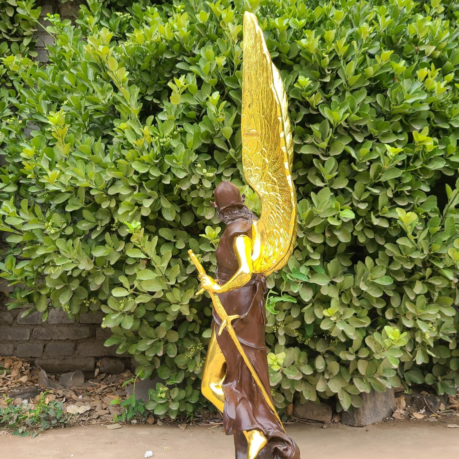 Detail of gold-finished angel wings on Athena Greek mythology bronze sculpture, handmade craftsmanship
