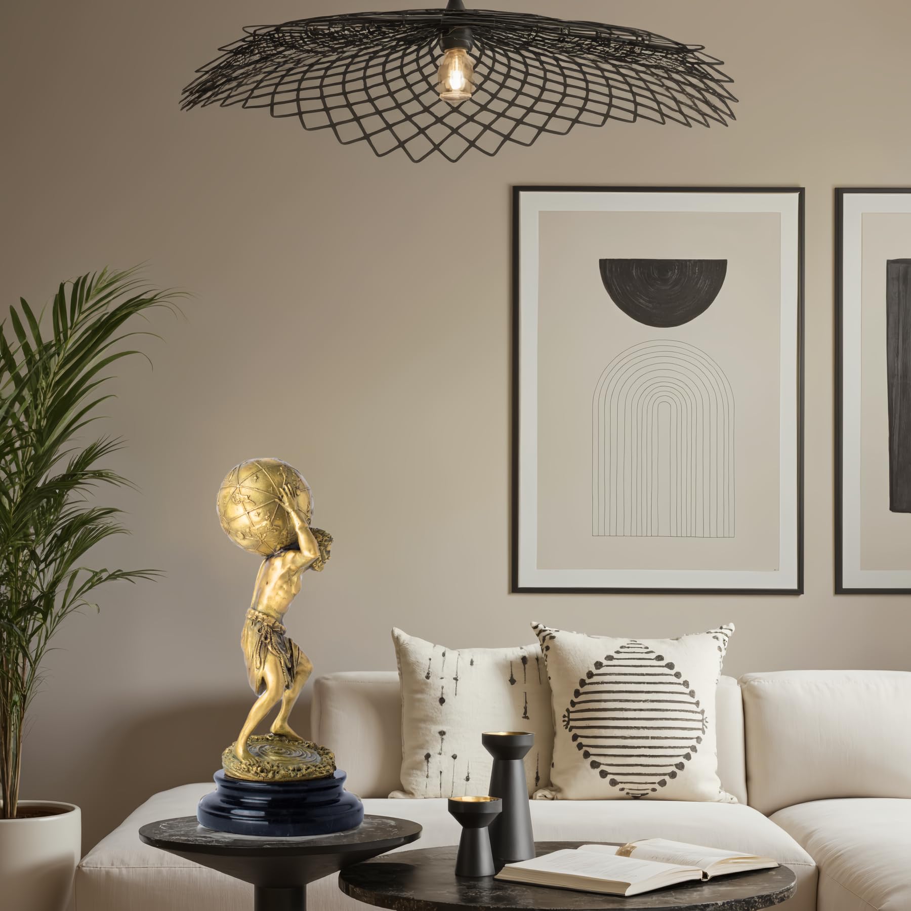Atlas bronze sculpture gold finish displayed beside luxury armchair interior