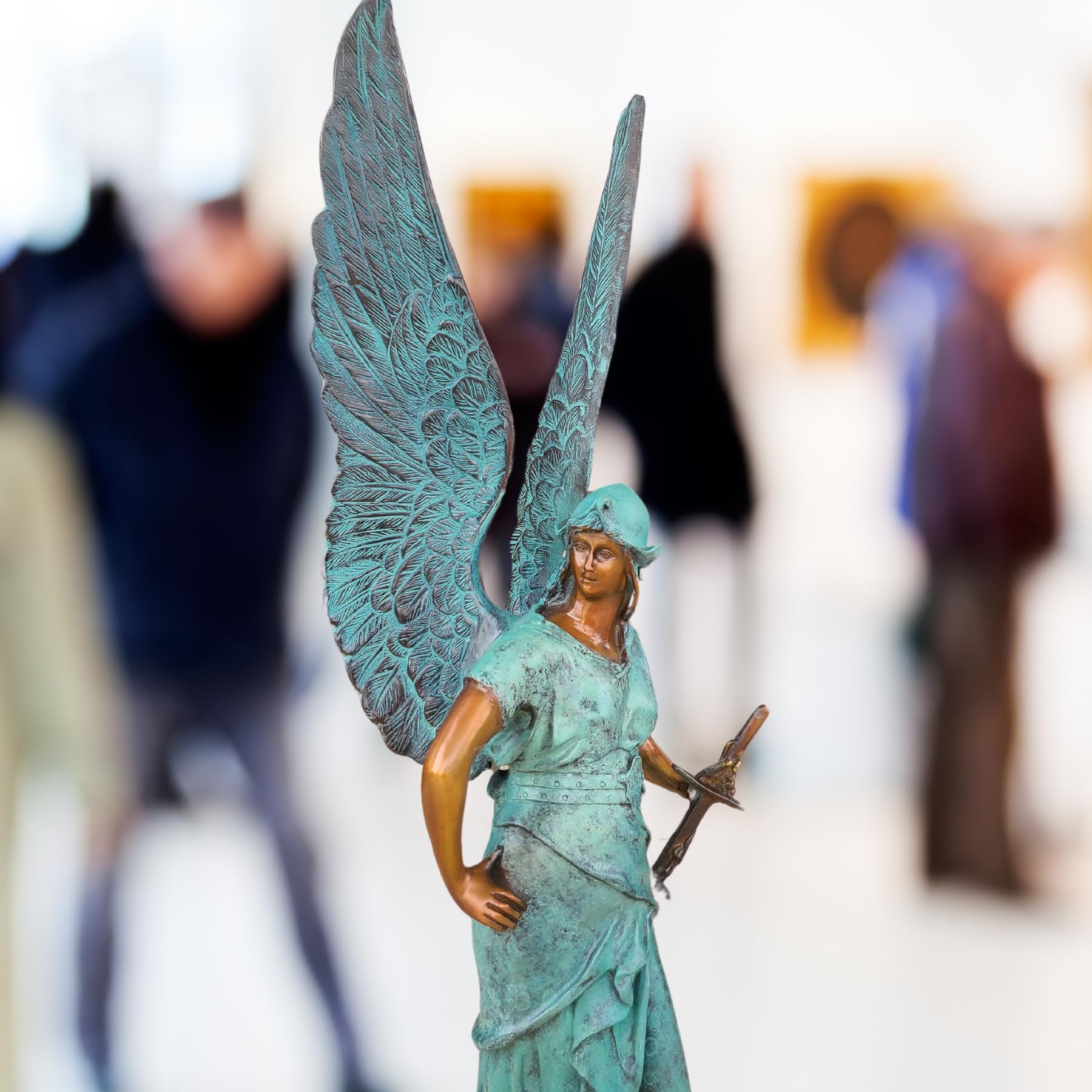 Close-up detail of classic bronze wing texture on Bellona winged goddess sculpture, lost-wax cast