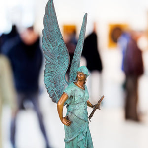 Close-up detail of classic bronze wing texture on Bellona winged goddess sculpture, lost-wax cast