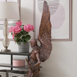 Close-up detail of classic bronze wing texture on Bellona winged goddess sculpture, lost-wax cast