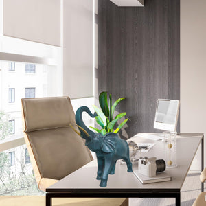Blue bronze elephant statue placed in living room beside modern chair as nordic home decor