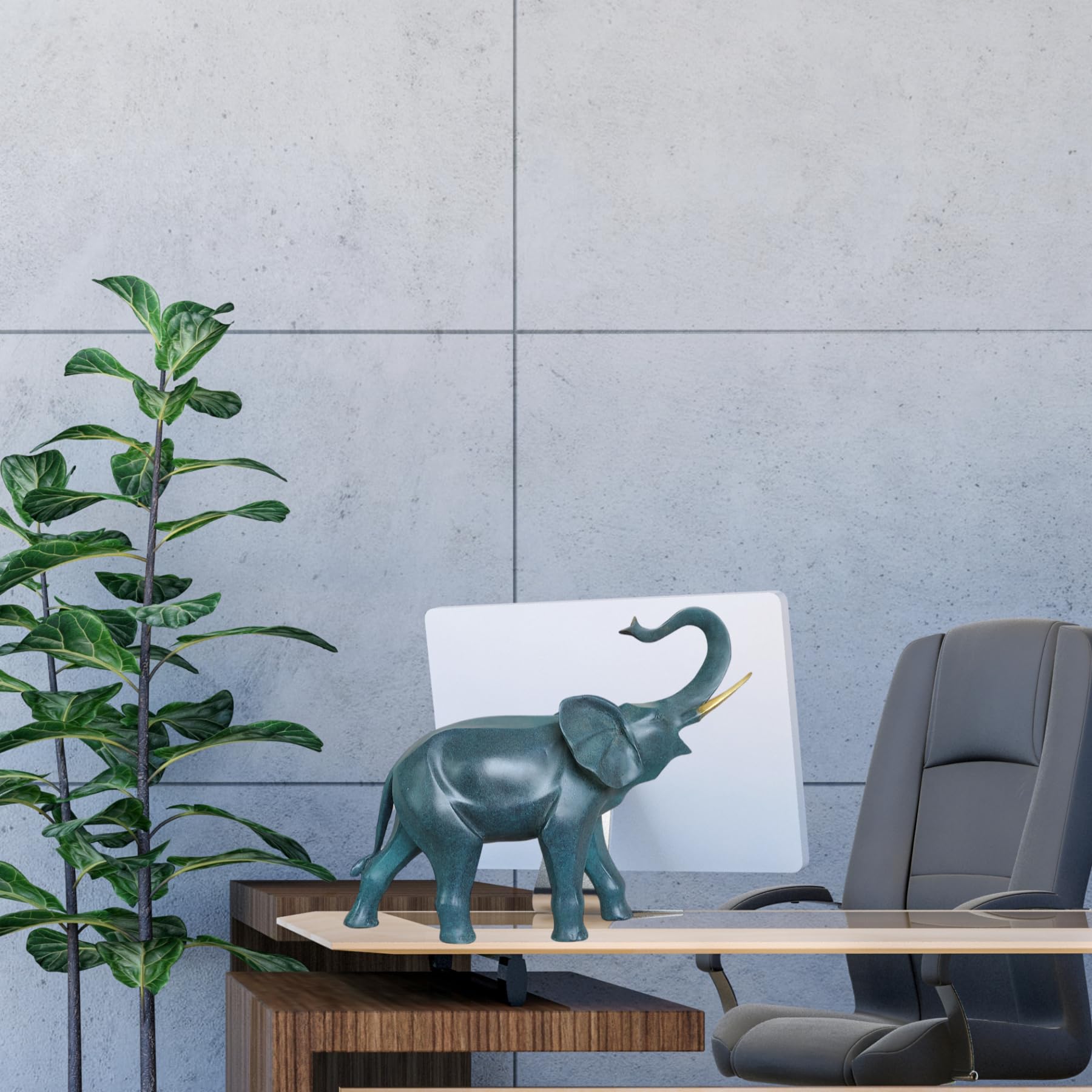 Blue bronze elephant statue with trunk down beside indoor plant against gray wall background