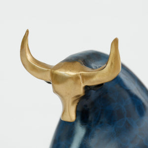 Close-up of the blue enamel bull head featuring detailed gold brass horns.