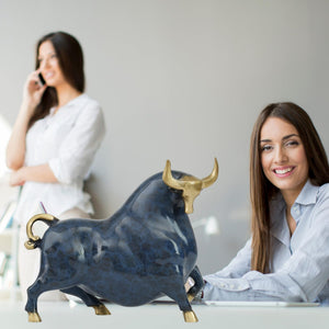 Luxury blue enamel bull sculpture displayed as modern office decor.