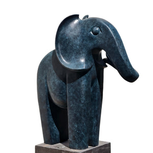 Blue patina bronze elephant statue left side view showing abstract geometric form and black base