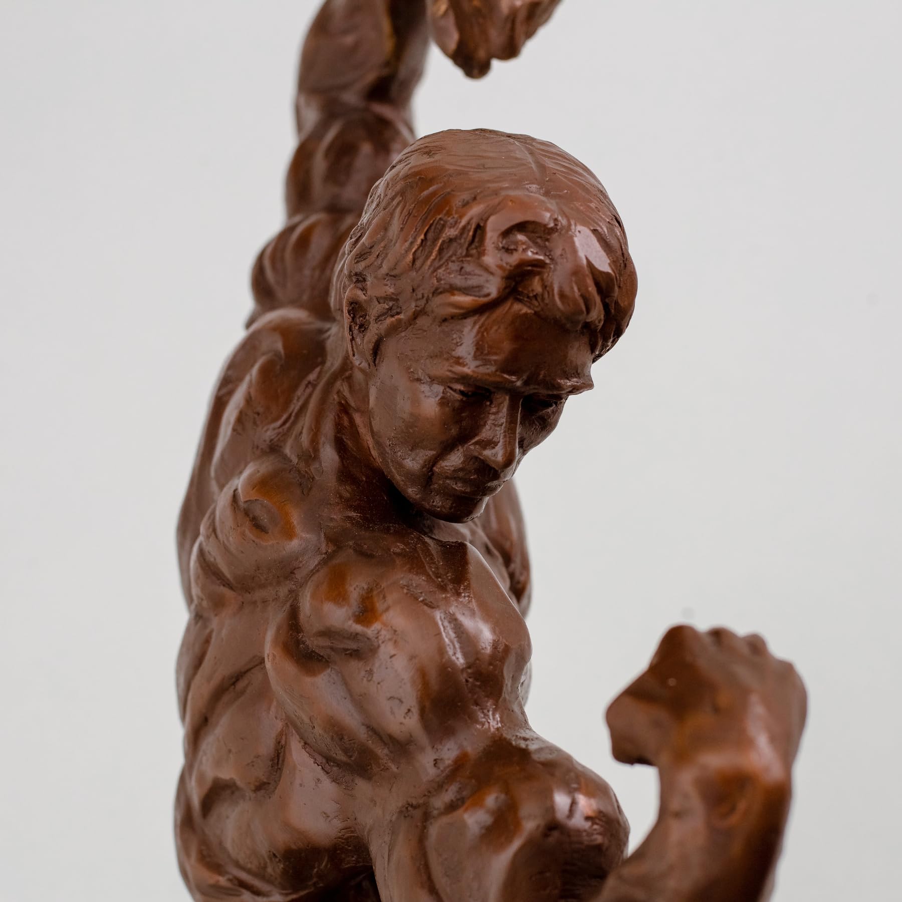 Side view close-up of 20lbs solid bronze bodybuilder sculpture showing detailed muscle anatomy
