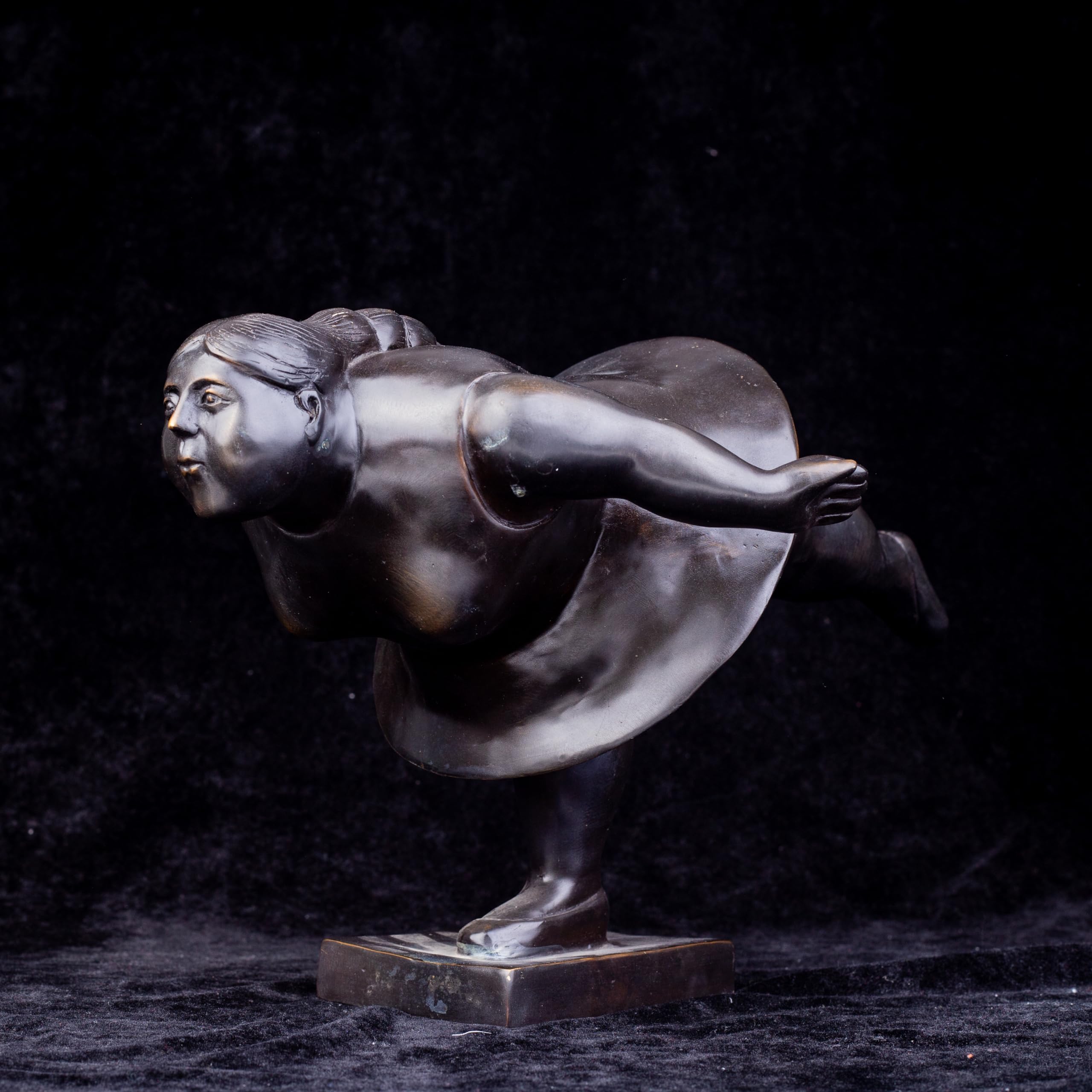 Botero bronze ballerina statue back angle view dark background