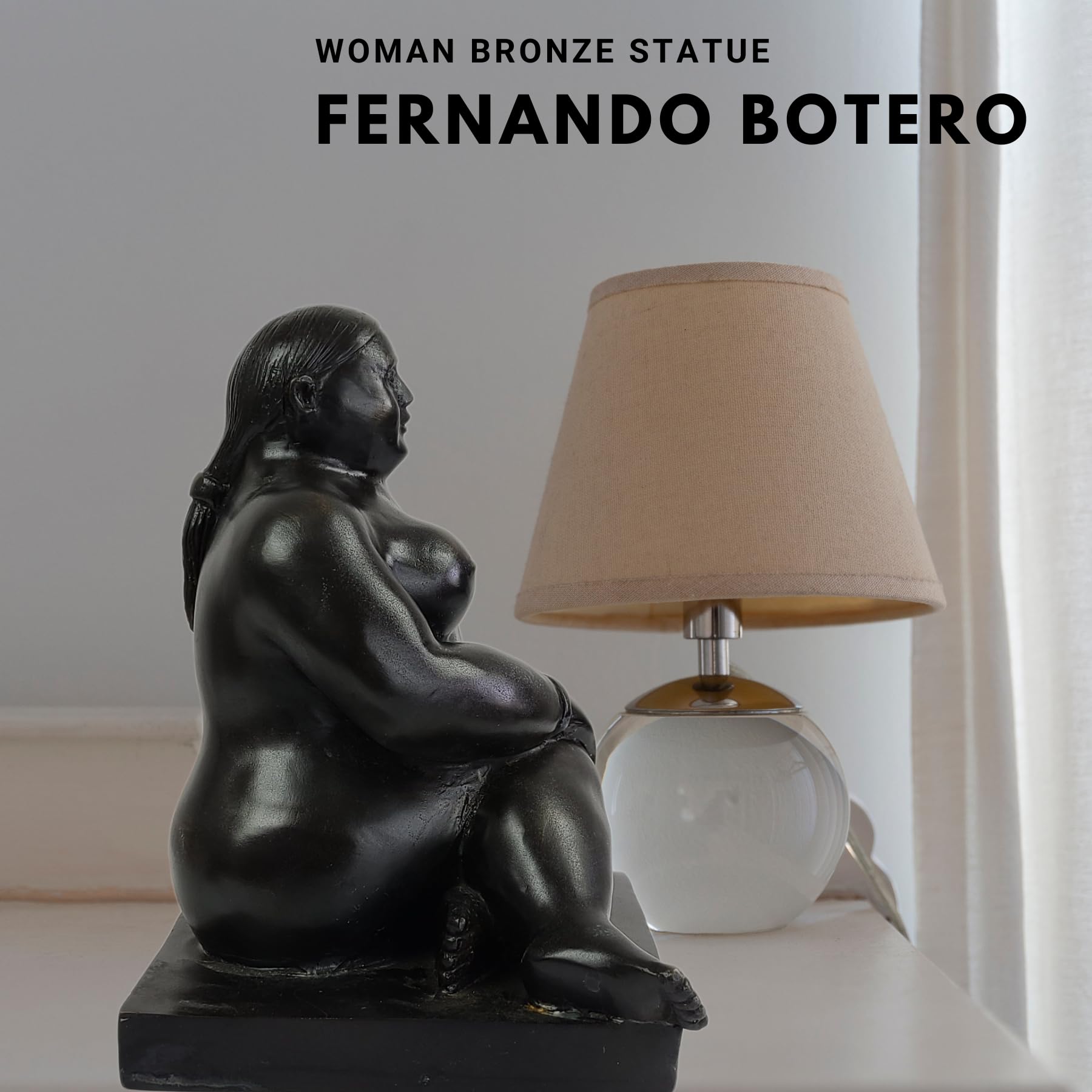 Botero bronze seated woman figurine displayed beside lamp in bedroom setting