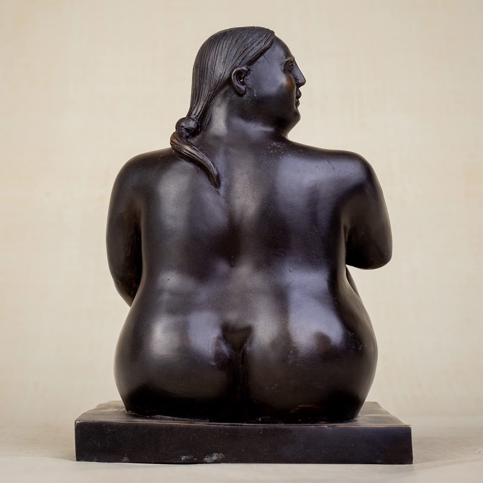 Right angle view of solid hot-cast bronze seated fat woman sculpture midnight obsidian patina