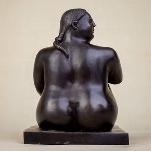 Right angle view of solid hot-cast bronze seated fat woman sculpture midnight obsidian patina