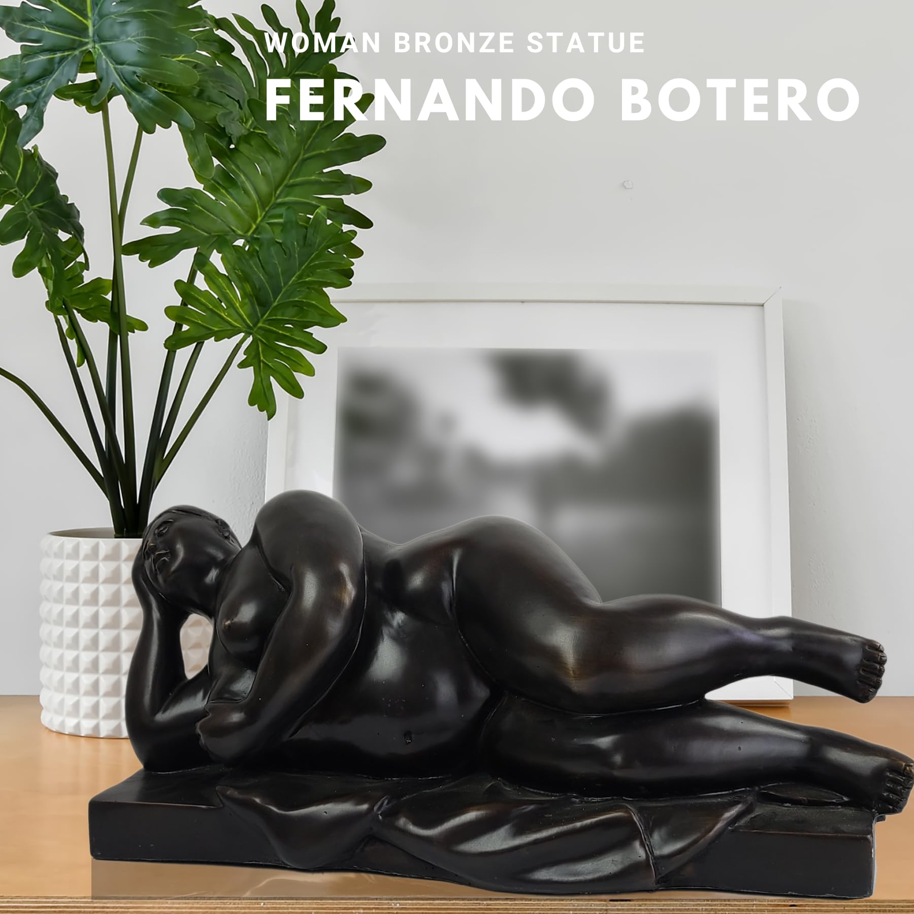 Botero style bronze reclining woman statue displayed in living room with plant
