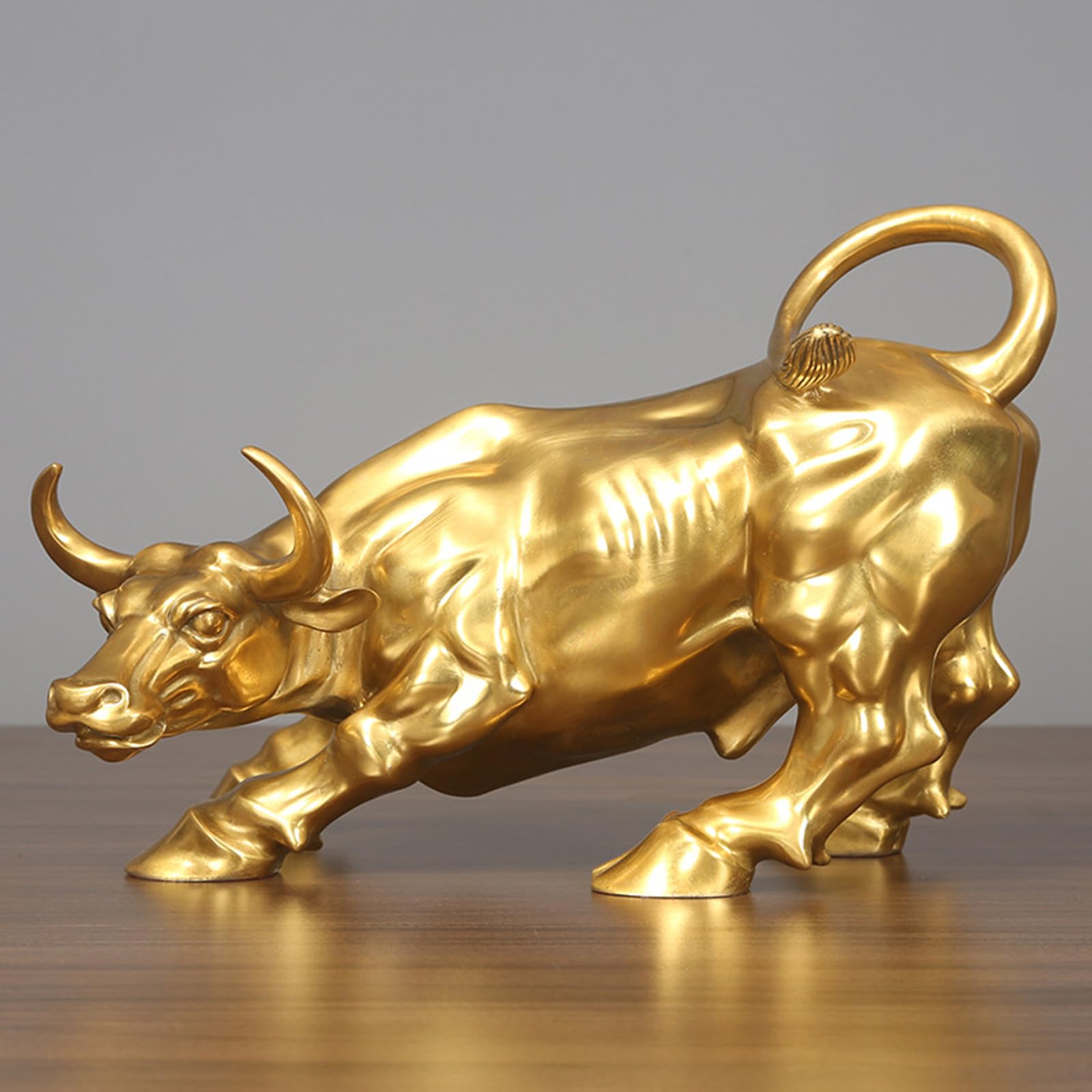 7.5-inch gold handcrafted brass charging bull statue, front view.