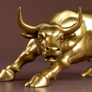 Front close-up of the golden brass bull figurine horn detail.