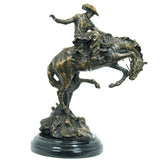 15-inch Frederic Remington Bronco Buster statue on circular marble base.