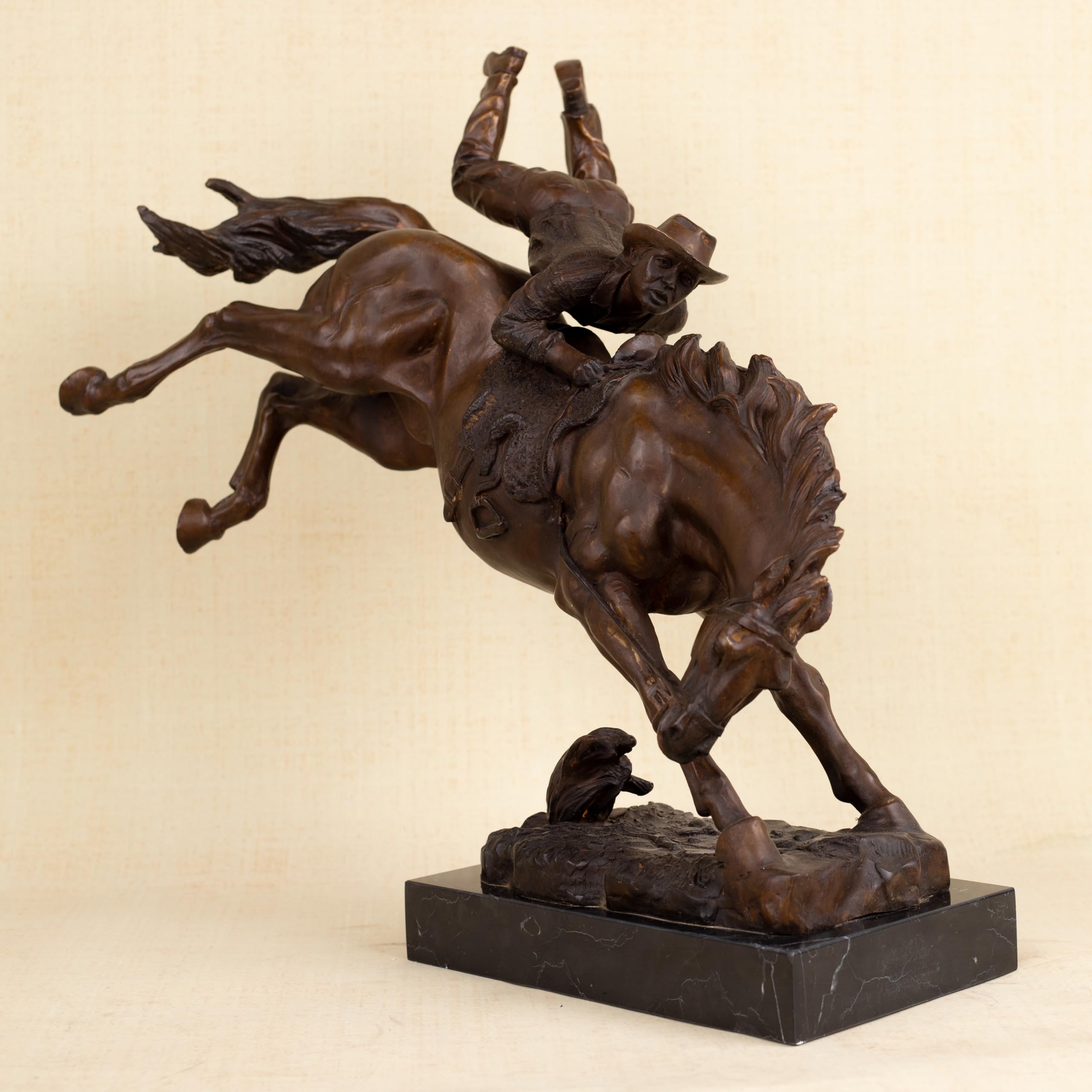 Rear angle view of large Bronco Buster bronze statue on polished black marble base, 14kg solid bronze