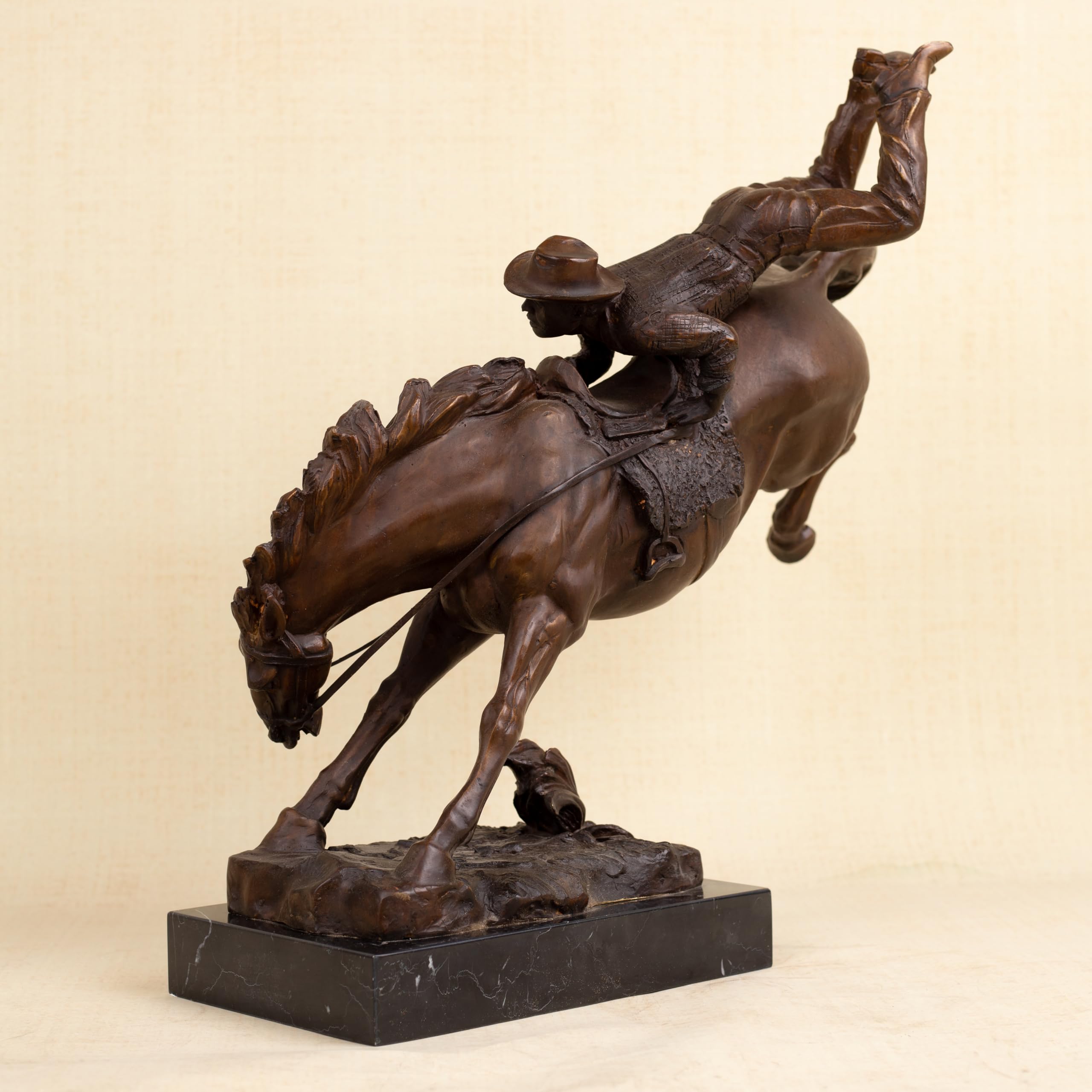 Size comparison display of large Bronco Buster bronze sculptures showing scale and heavyweight construction