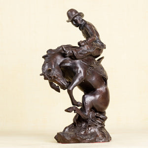 Left angle view of Style 3 Bronco Buster bronze cowboy taming wild horse