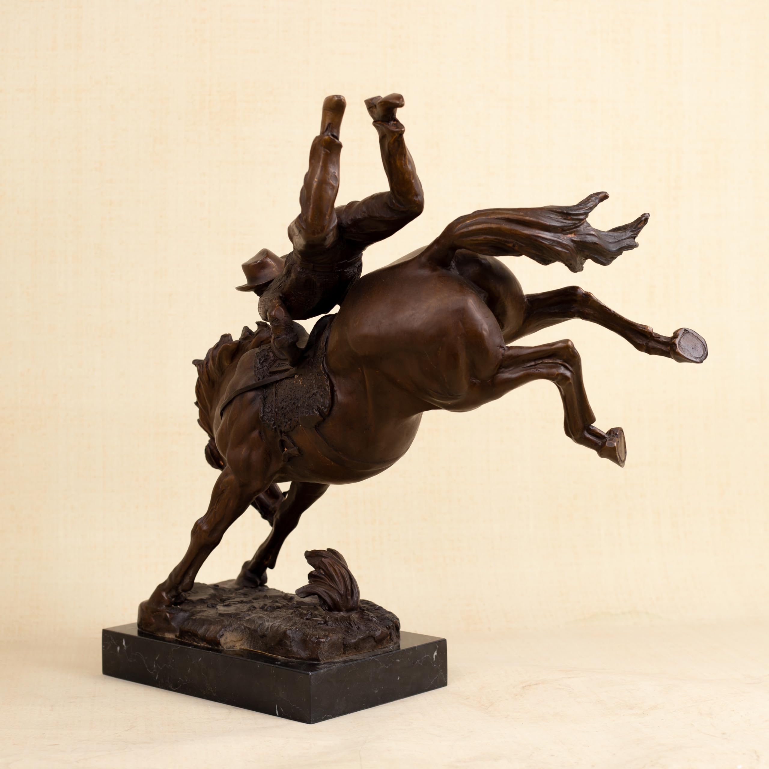 Top angle view of large Bronco Buster bronze sculpture highlighting cowboy figure detail and saddle