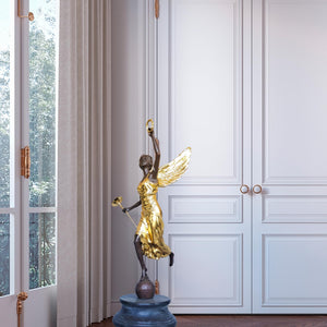 Bronze angel statue pair displayed beside fireplace white brick interior