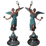 Pair of bronze angel statues trumpet laurel wreath verdigris patina front view both figures