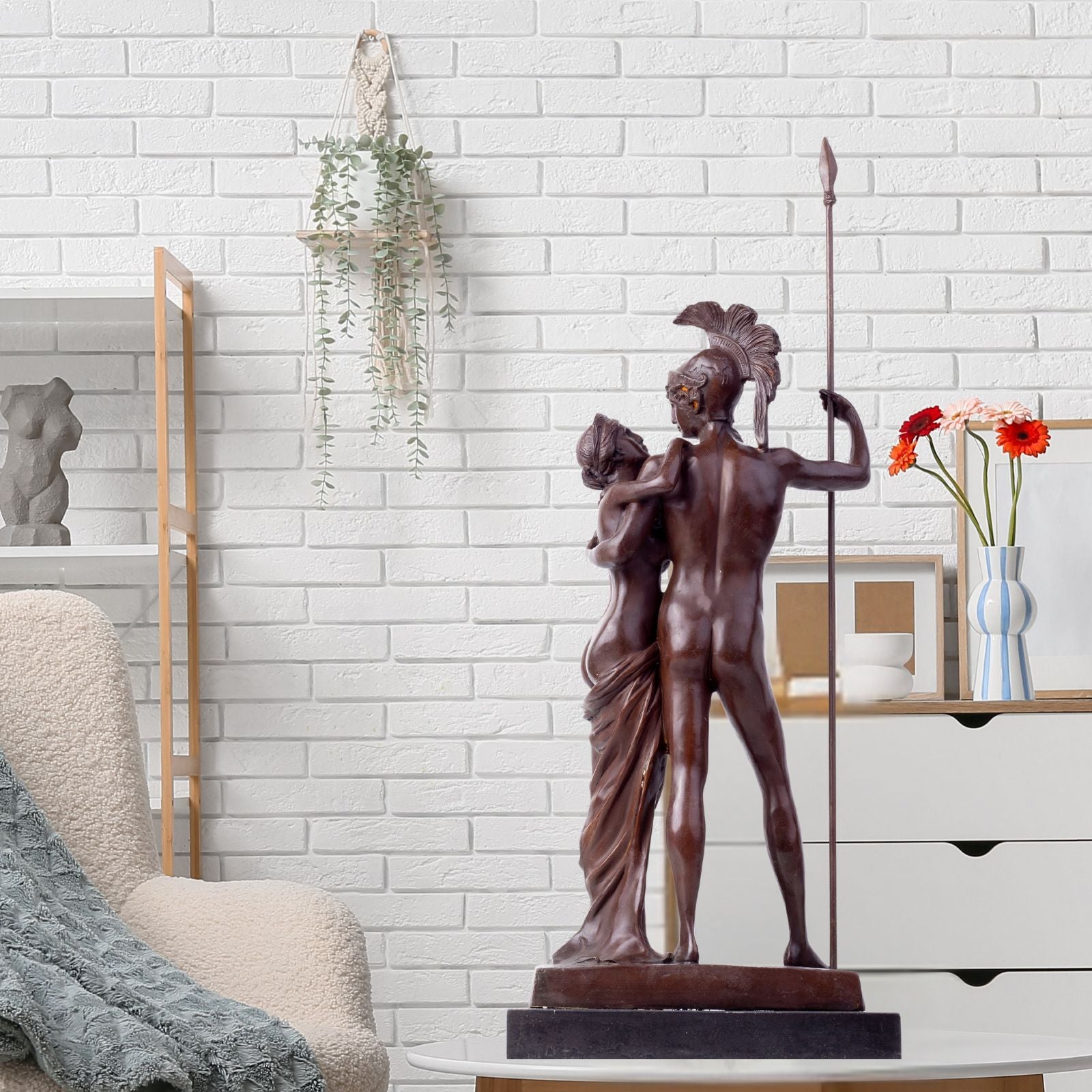 Bronze Ares and Aphrodite Greek mythology sculpture in indoor white wall setting with floral decor