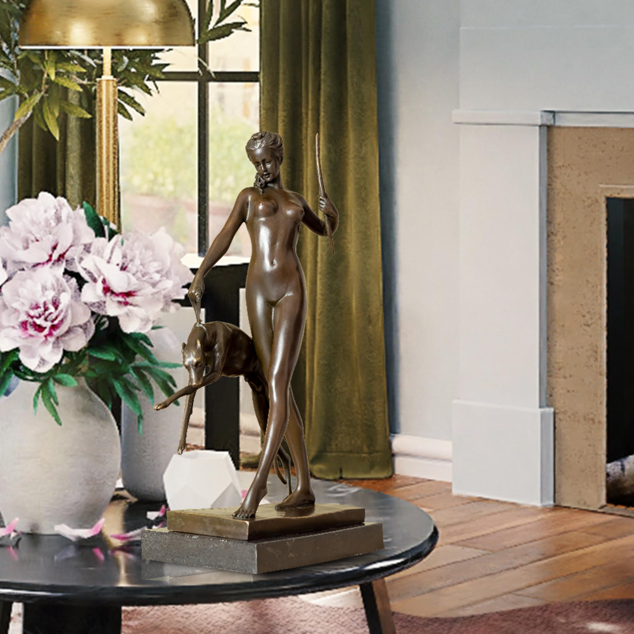Bronze Artemis Greek goddess sculpture on indoor side table styled with floral arrangement