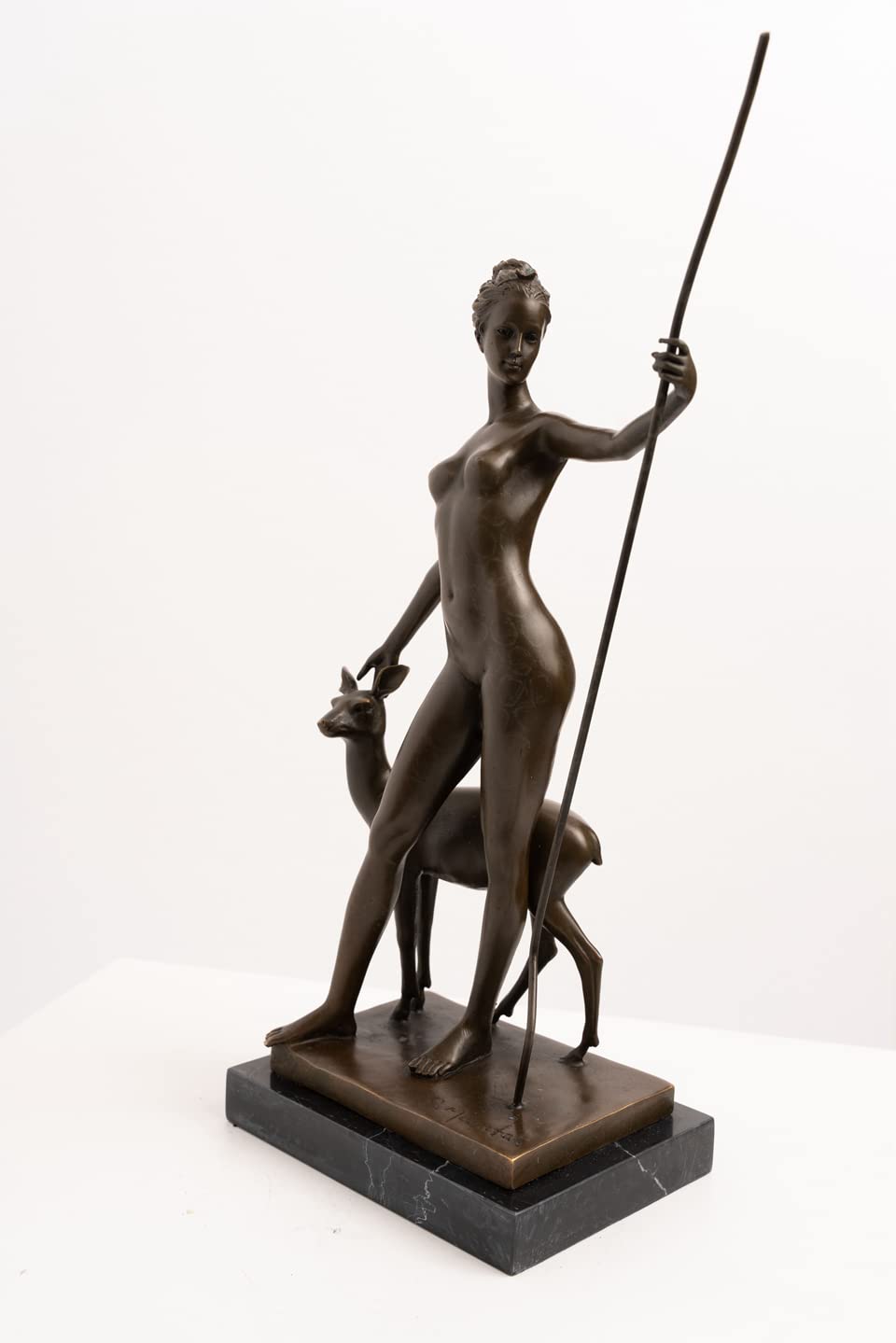 Angled view of bronze Artemis huntress and fawn classical sculpture
